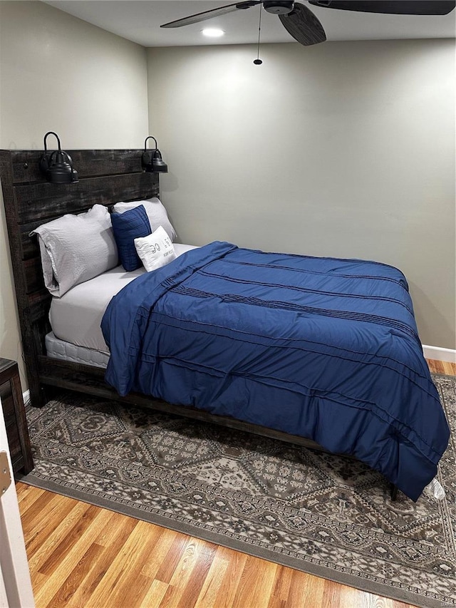 bedroom with hardwood / wood-style floors and ceiling fan