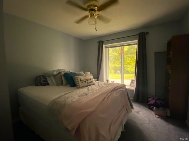 bedroom featuring ceiling fan and carpet