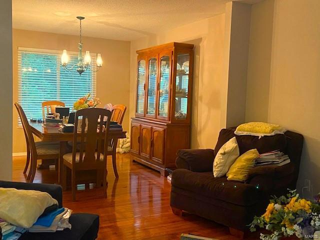 dining space featuring an inviting chandelier and wood-type flooring