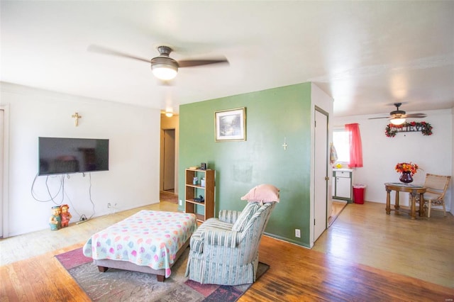 living room featuring ceiling fan and wood-type flooring