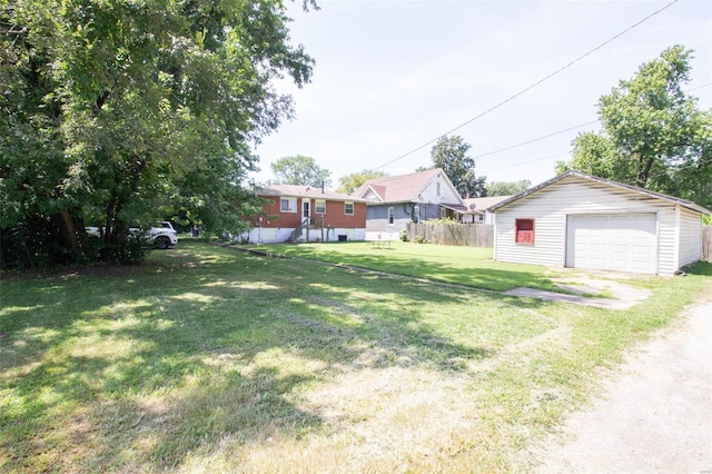 view of yard with a garage and an outbuilding