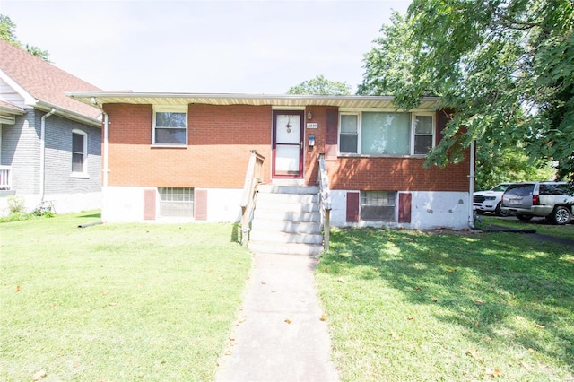 raised ranch featuring a front lawn