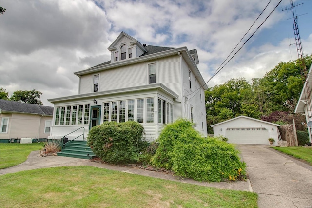 front of property featuring an outdoor structure, a garage, and a front lawn