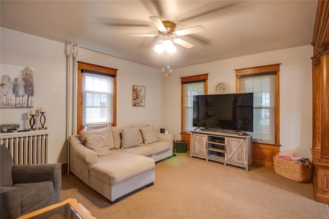 carpeted living room featuring ceiling fan