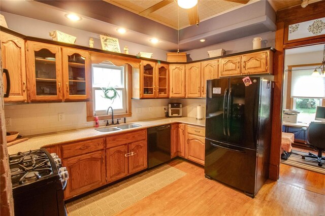 kitchen featuring sink, black appliances, a healthy amount of sunlight, and ceiling fan