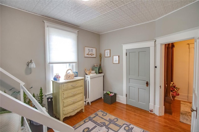 interior space with radiator heating unit and light hardwood / wood-style floors