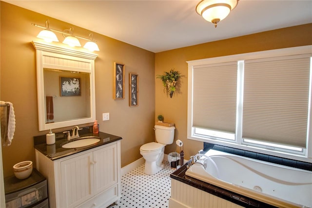 bathroom with tile patterned floors, vanity, tiled tub, and toilet