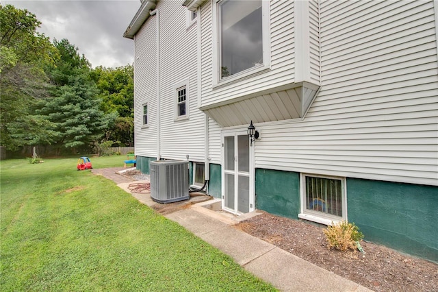 view of home's exterior with a lawn and cooling unit