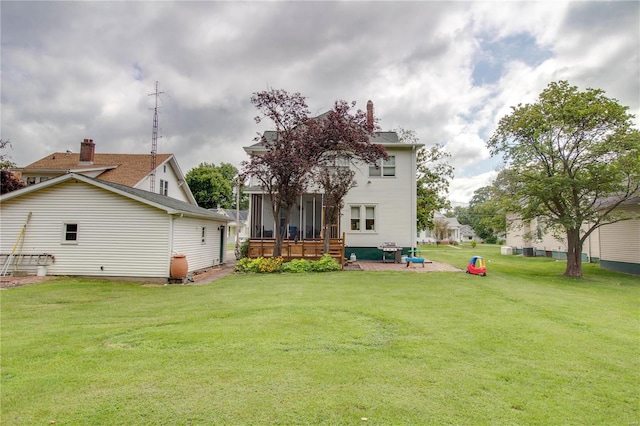 back of house with a lawn