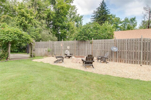 view of yard with a fire pit