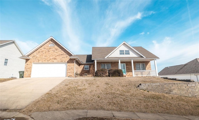 view of front facade featuring brick siding, a porch, a front yard, a garage, and driveway