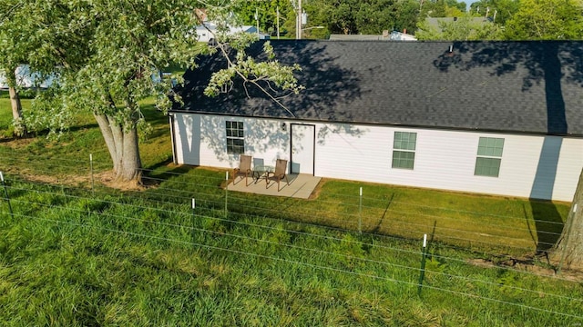 back of house featuring a patio and a lawn