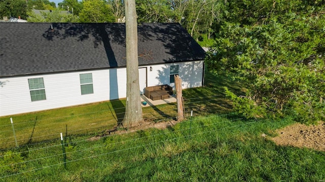 view of side of home with a yard