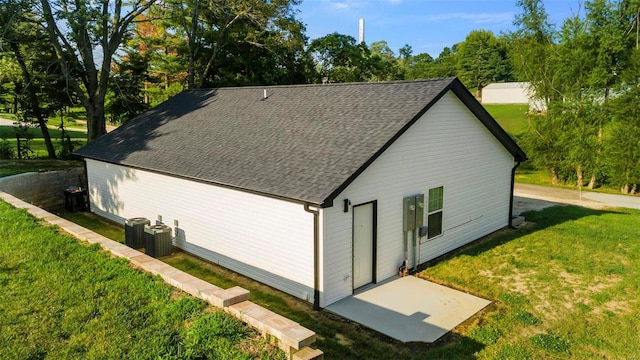 exterior space with central AC and a lawn