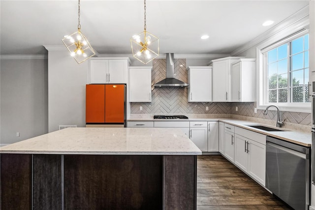 kitchen featuring dishwasher, wall chimney exhaust hood, a kitchen island, pendant lighting, and a sink