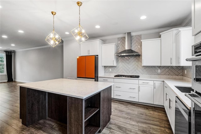 kitchen with open shelves, wall chimney range hood, a kitchen island, and white cabinets