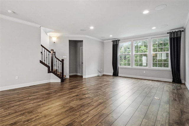 spare room featuring stairs, ornamental molding, dark wood finished floors, and baseboards