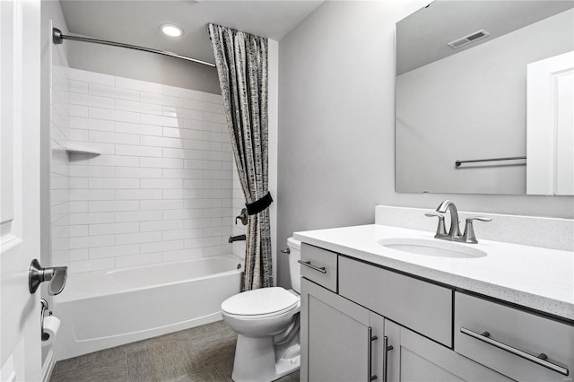 bathroom featuring shower / bath combination with curtain, visible vents, vanity, and toilet