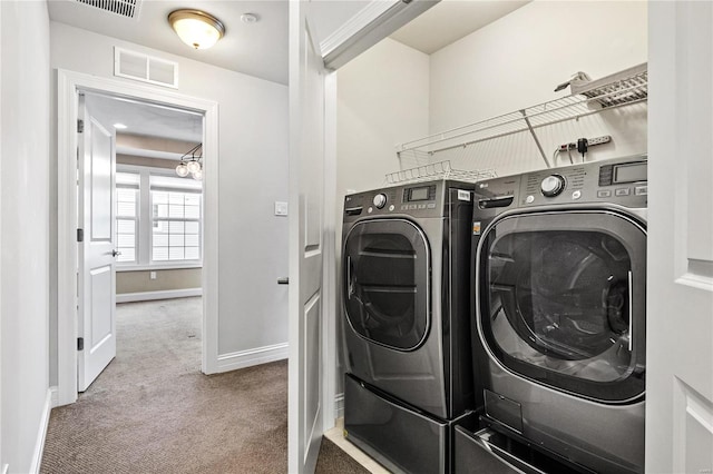 laundry room featuring carpet floors, laundry area, visible vents, and washing machine and clothes dryer