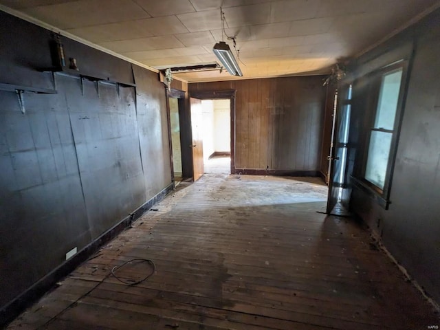 interior space with hardwood / wood-style flooring and wooden walls