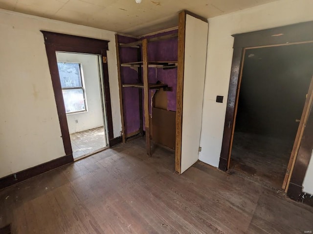 unfurnished bedroom featuring dark hardwood / wood-style flooring and a closet