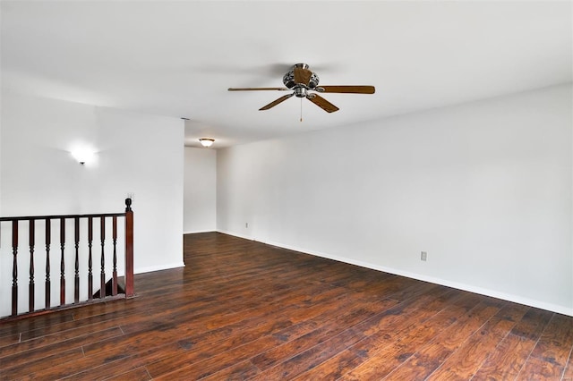 spare room with hardwood / wood-style flooring, baseboards, and a ceiling fan