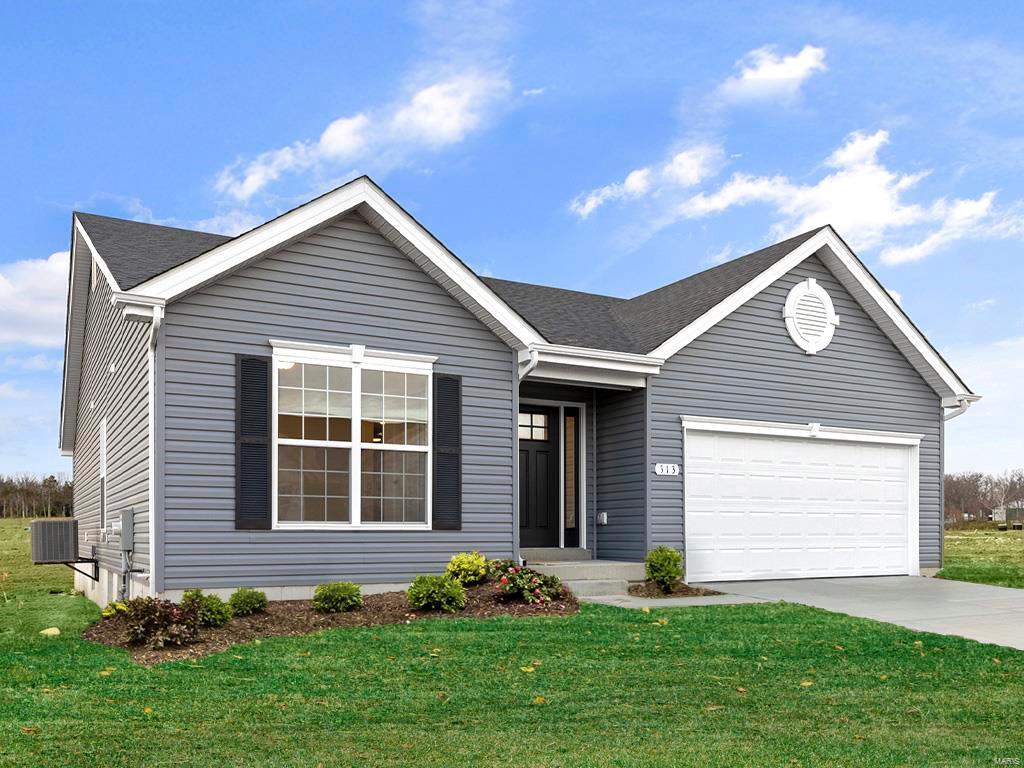 ranch-style home featuring a garage and a front lawn