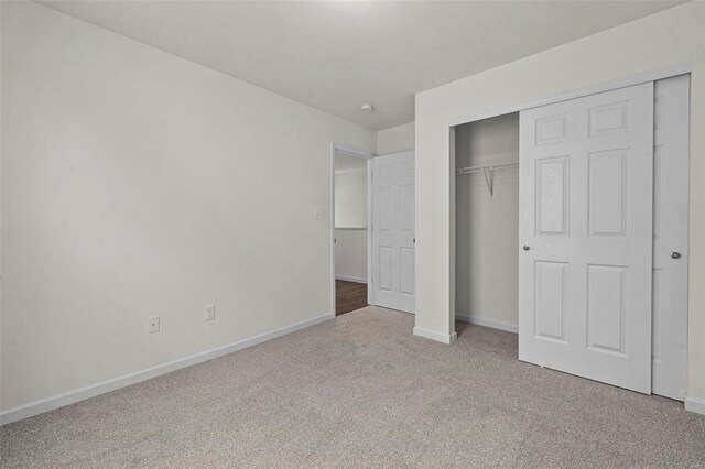 unfurnished bedroom with a closet and carpet