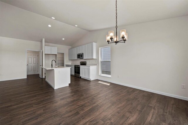 kitchen with a center island with sink, dark hardwood / wood-style floors, and stainless steel appliances