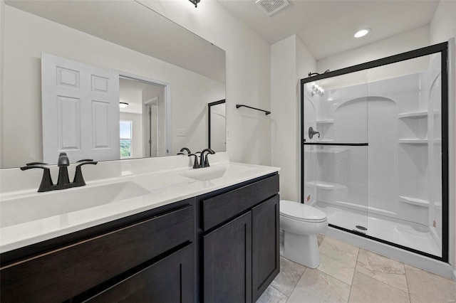 bathroom featuring toilet, walk in shower, tile patterned flooring, and dual bowl vanity