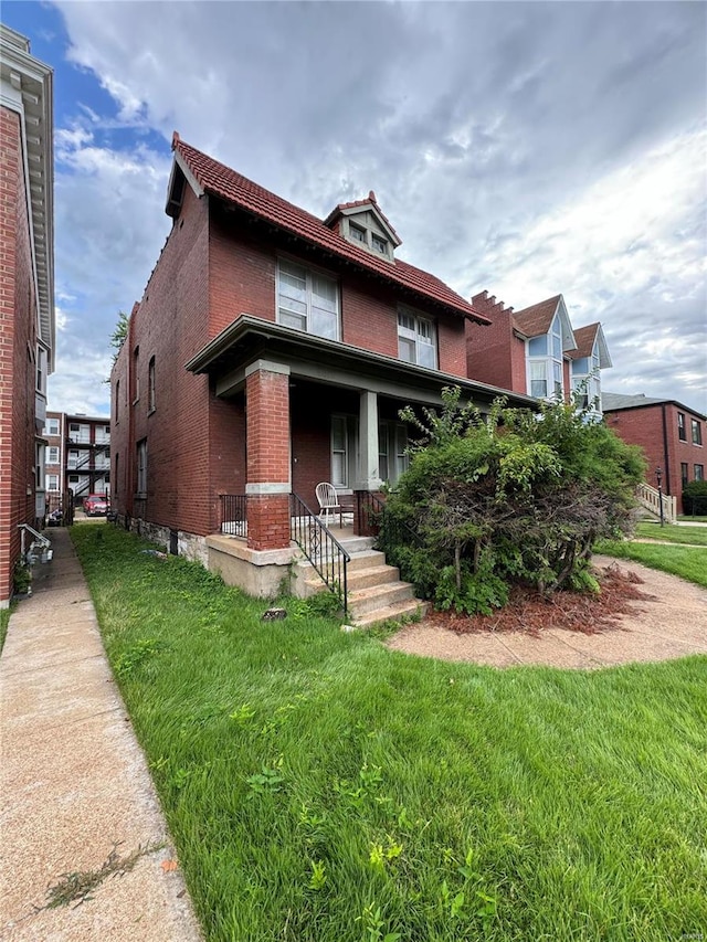 view of front of house with a porch and a front lawn