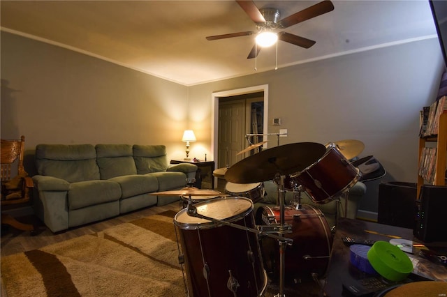 living room featuring carpet flooring, ceiling fan, and ornamental molding