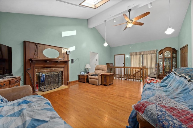 bedroom featuring high vaulted ceiling, light hardwood / wood-style floors, a skylight, and beamed ceiling