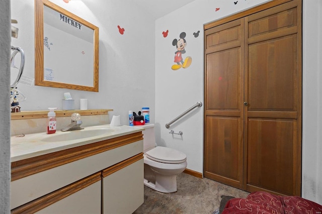 bathroom with tile patterned flooring, toilet, and vanity