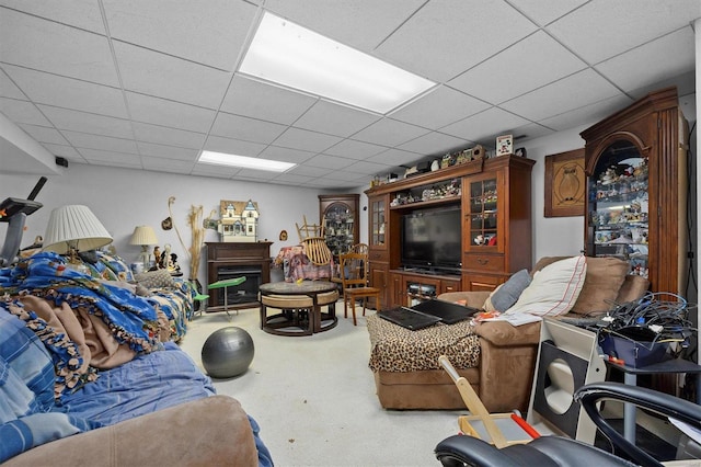 carpeted living room with a drop ceiling