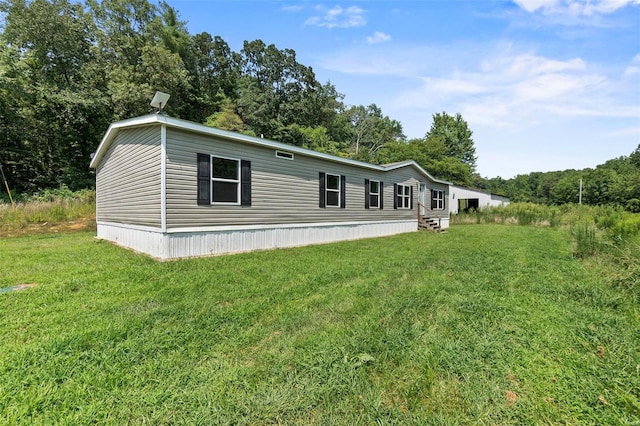 rear view of property featuring a lawn