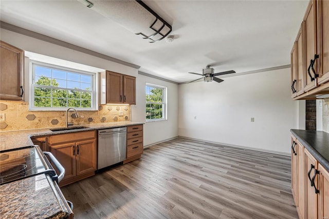 kitchen featuring sink, crown molding, dark hardwood / wood-style flooring, dishwasher, and backsplash