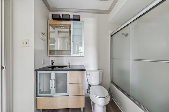 full bathroom with crown molding, vanity, shower / bath combination with glass door, and hardwood / wood-style flooring