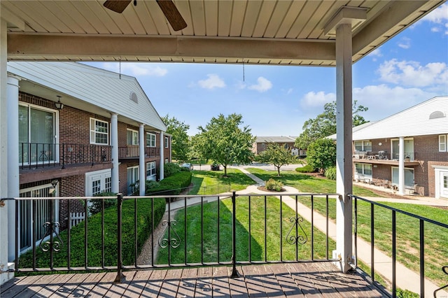 exterior space with a balcony and ceiling fan