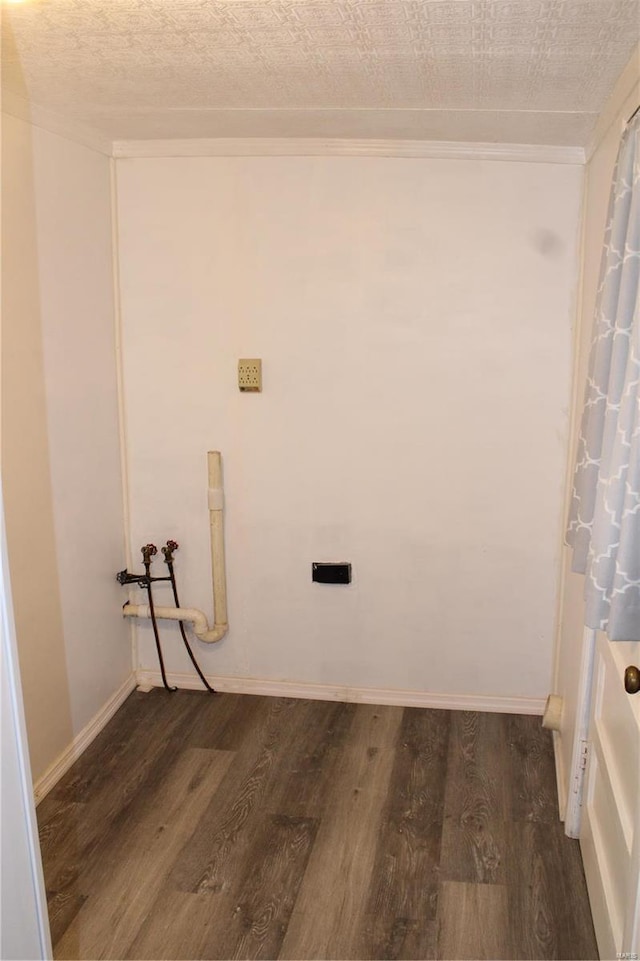 clothes washing area featuring dark wood-type flooring, washer hookup, and a textured ceiling