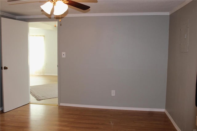 unfurnished room with hardwood / wood-style flooring, ceiling fan, and ornamental molding