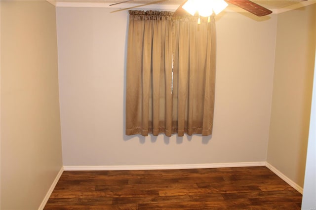 spare room with dark wood-type flooring and ceiling fan