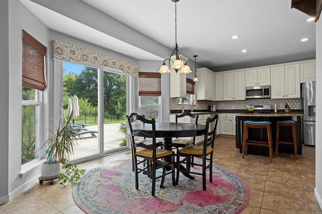 dining area with baseboards and recessed lighting