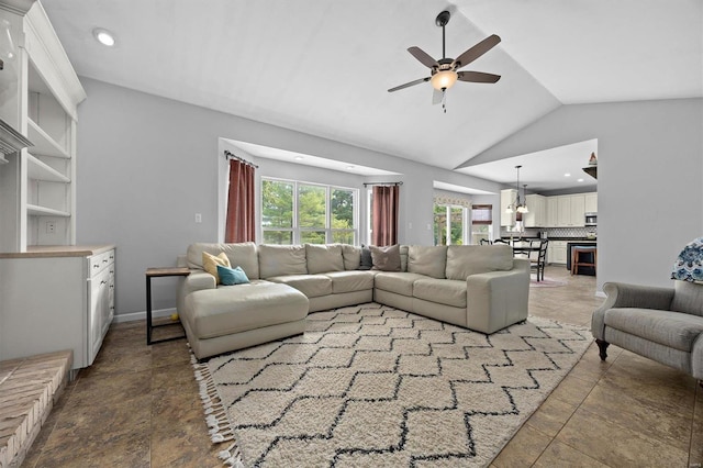 tiled living room featuring ceiling fan and lofted ceiling