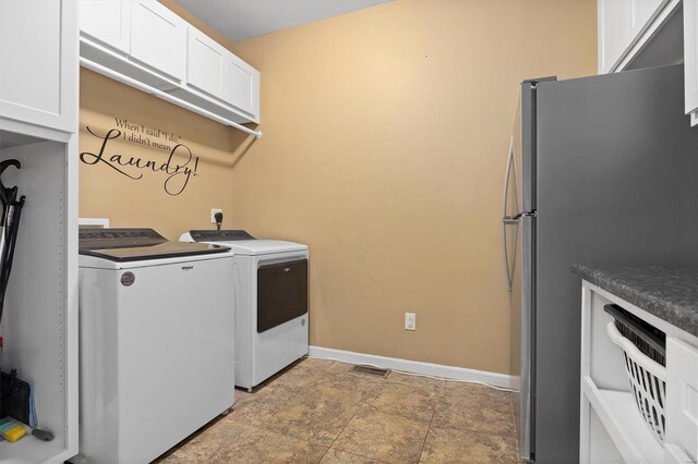 laundry area with tile patterned floors, cabinets, and separate washer and dryer