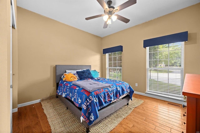 bedroom with ceiling fan and light hardwood / wood-style floors