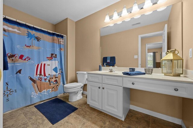 bathroom featuring toilet, tile patterned floors, and vanity