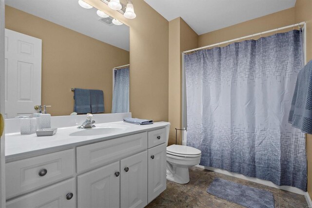 bathroom with tile patterned floors, vanity, and toilet