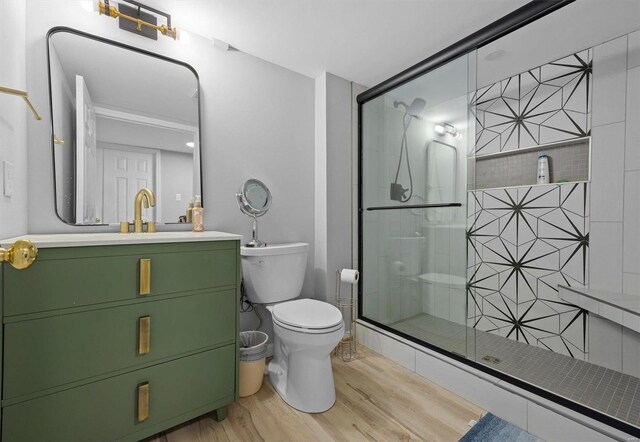 bathroom featuring an enclosed shower, hardwood / wood-style flooring, vanity, and toilet