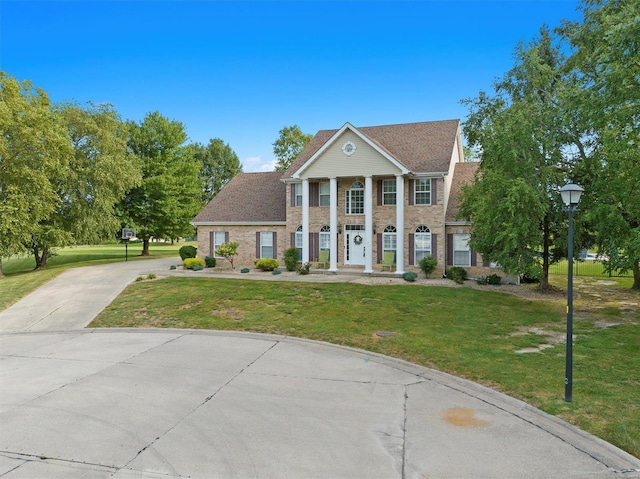 neoclassical / greek revival house with a front yard